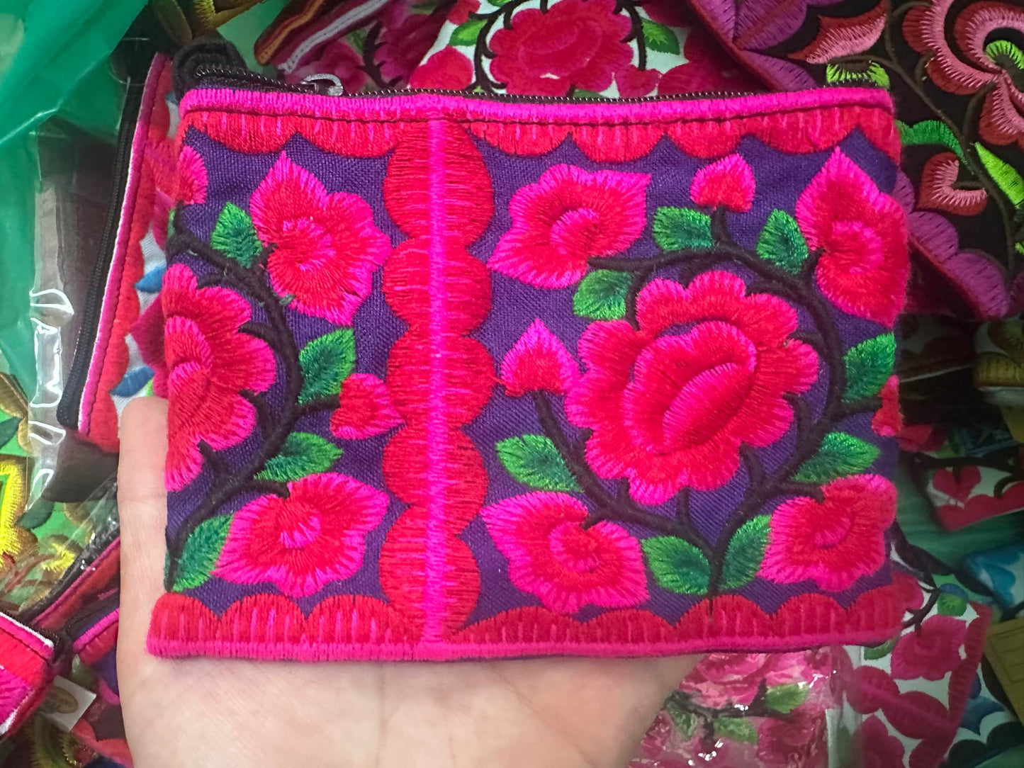 Hilltribe coin purse, embroidered, with designs on both sides. Has a wrist strap, zipper and lining. Size 4x5.5 inches.