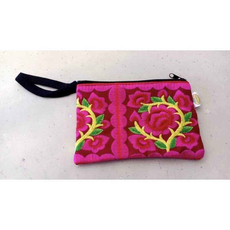 Hilltribe coin purse, embroidered, with designs on both sides. Has a wrist strap, zipper and lining. Size 4x5.5 inches.